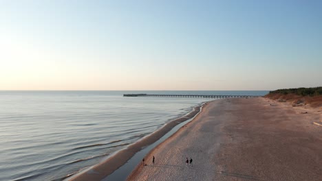 AERIAL:-Palanga-Pier-During-Golden-Hour-with-Sandy-Beach-and-Clear-Blue-Sky