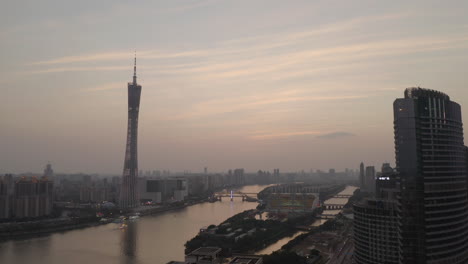 View-of-Guangzhou-downtown-area-with-Canton-tower,-pearl-river-and-downtown-office-buildings-district-on-sunset