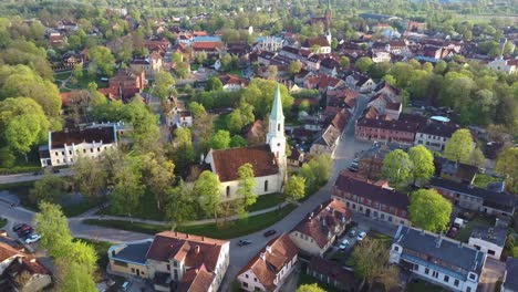 Aerial-View-of-Kuldiga-Old-Town-With-Red-Roof-Tiles-and-Evangelical-Lutheran-Church-of-Saint-Catherine-in-Kuldiga,-Latvia