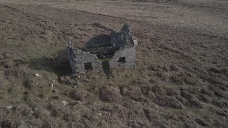 Ruins-Of-Abandoned-Concrete-Cottage-In-Irish-Rural-Landscape