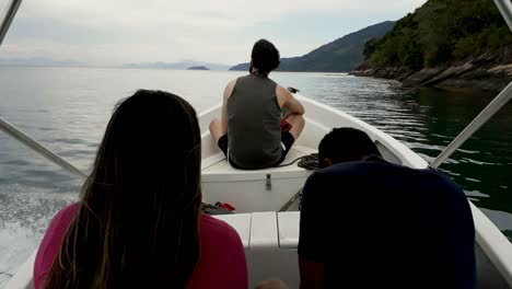 back-view-of-people-sailing-on-motorboat-in-the-bay-surrounded-by-mountains-in-Paraty,-Brazil