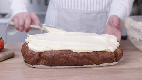 Baker-Spreading-Icing-on-Carrot-Cake-with-Spatula