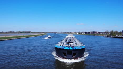 Oil-Tanker-Barge-Sailing-At-River-Noord-With-Blue-Sky-In-Background-At-Hendrik-Ido-Ambacht,-Netherlands