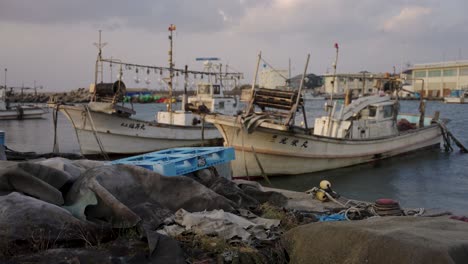 Fishing-boats-in-harbor,-slow-motion-pan-across-Mikuriya,-Tottori-Japan