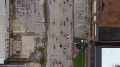 4k-Birds-eye-view-of-bicyclists-riding-through-streets