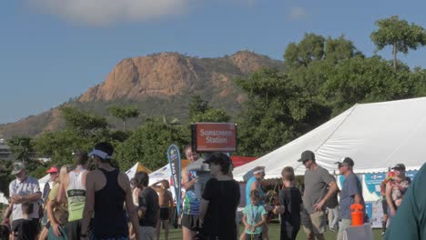 Fun-Run-Participants-Standing-At-Sunscreen-Station---Townsville-Running-Festival-In-Queensland,-Australia