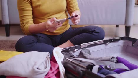 Detail-of-Women-booking-flights-online-with-her-cell-phone-and-credit-card-for-travel-in-the-summertime