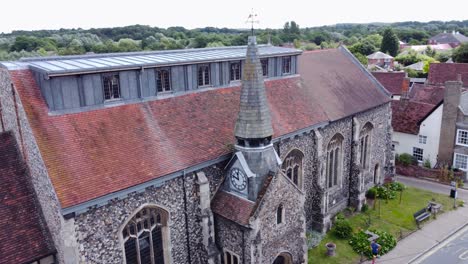 Aerial-close-up-of-old-christian-church-in-needham-market,-bell-tower-and-clock-in-a-characteristic-English-little-town
