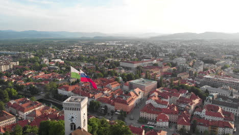 Stady-4K-dron-shot-of-a-castle-in-Ljubljana-with-flag-of-Slovenia-and-city-view