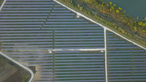 Top-down-aerial-view-of-solar-panels-surrounded-by-agricultural-land---wide-shot