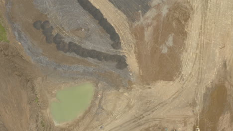 Aerial-fly-over-quarry-with-dormant-machinery-lined-up-ready-for-usage