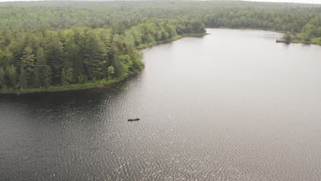 Aerial-orbiting-around-canoe-fishing-on-beautiful-scenic-wild-lake