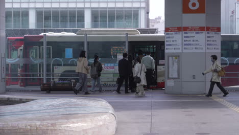 Japanese-Commuters-Getting-On-The-Bus-In-Kanazawa-City,-Japan