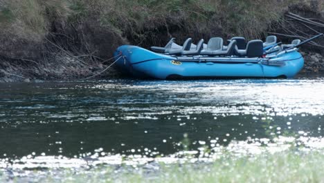 Blue-NRS-inflatable-rafts-await-tourists-on-early-morning-riverbank