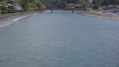 Uji-river-and-bridges-in-Spring,-Tilt-reveal-of-beautiful-Japanese-town