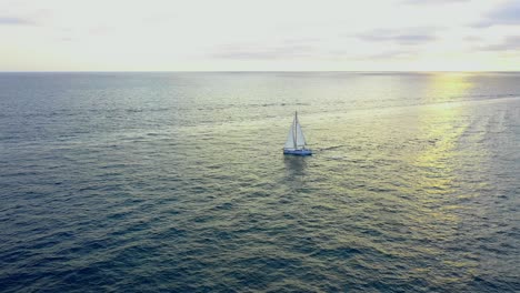 Drone-view-of-a-sailboat-during-sunset-in-the-pacific-ocean