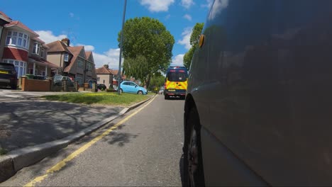 POV-From-Side-Of-Car-Following-Behind-Police-Van-On-Imperial-Drive-A4090-In-Harrow,-London