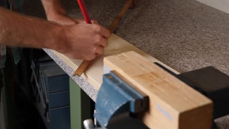 Cross-markings-on-wood-deck-using-ruler