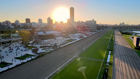 Sun-sets-over-Hipodromo-Argentino-de-Palermo-horse-racing-track,-spectators-gathering
