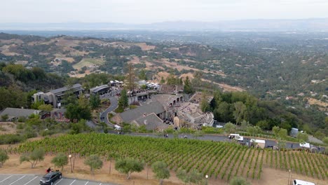 Aerial-around-the-mountain-winery-with-a-view-of-countryside-of-Saratoga-in-the-background---orbit,-drone-shot