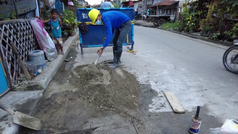 Foremen-wearing-safety-reflective-vests-used-their-shovel,-mixed-cement,-and-demolition-hammer-to-perform-excavation-beside-the-road-gutter-to-install-new-water-piping-from-the-main-water-line