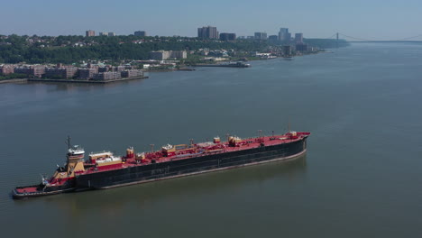 A-drone-view-of-a-large-red-barge-on-the-Hudson-River-in-NY-on-a-sunny-day
