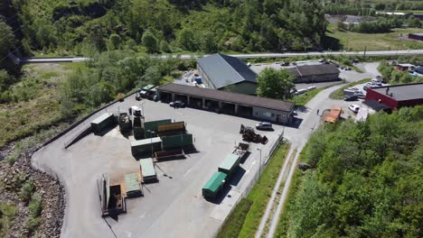 Garbage-segregation-and-recycling-plant-BIR-Dalekvam---Reverse-sunny-day-aerial-showing-waste-containers-and-cars-arriving