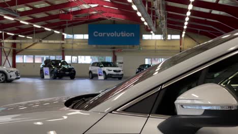 Reveal-shot-of-cars-inside-Carvolution-HQ-in-Bannwil,-Switzerland