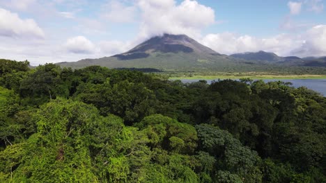 Aerial-footage-of-ascending-backwards-flight-revealing-the-thick-rainforest-that-surrounds-Arenal-Volcano