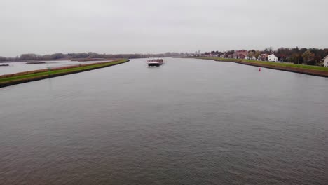 Bolero-Cargo-Ship-Navigating-River-Noord-In-Distance