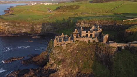 Aerial-view-of-Dunluce-Castle-on-a-sunny-evening,-County-Antrim,-Northern-Ireland