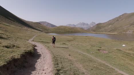 Young-Man-walking-in-the-mountains-on-a-Sunny-day-in-french-pyrenees-close-to-a-lake