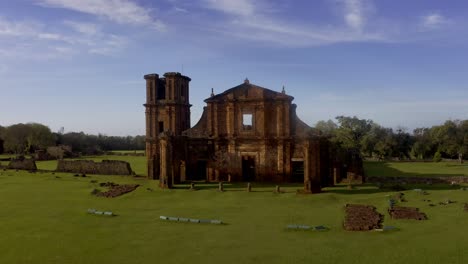 The-ancient-ruins-of-the-Jesuit-Misson-Church-made-of-red-sandstone---push-in-aerial-view