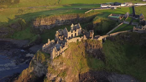 Aerial-view-of-Dunluce-Castle-on-a-sunny-evening,-County-Antrim,-Northern-Ireland