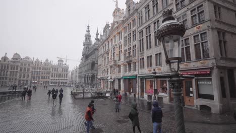 Skyline-panorama-of-the-Grand-Square-during-winter-snowfall---Wide-angle-panning-view---Belgian-capital-Belgium