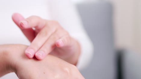 Detail-of-female-hands-applying-moisturizing-hand-lotion