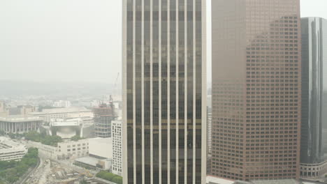 Pull-in-to-skyscraper-in-downtown-Los-Angeles-on-a-smokey-day