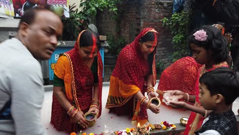 Shot-of-the-Indian-women's-doing-chatt-puja-standing-inside-the-water-on-the-road-in-front-of-the-people-in-Kolkata