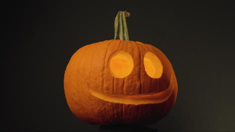 Pumpkin-Head---Pumpkin-With-Carved-Round-Eyes-And-Mouth-In-Black-Background