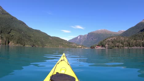 Beautiful-day-kayaking-emerald-green-glacial-lake-Lovatnet-Norway---POV-shot-from-chestmounted-actioncamera-with-kayaking-movements---Beautiful-landscape-during-summer-vacation