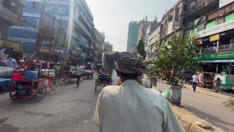 Using-a-local-cycle-rickshaw-taxi-for-transportation-in-Dhaka,-Bangladesh---pov-shot