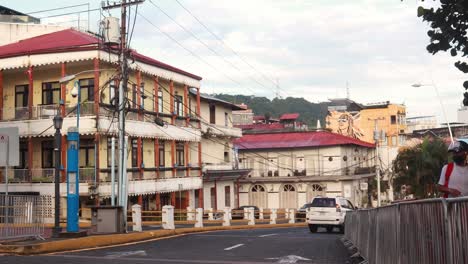 A-static-shot-of-street-side-residential-buildings-which-reflect-the-rich-Hispanic-influence-in-the-design-and-architecture-of-the-city,-in-the-distance-the-iconic-Ancon-Hill,-Casco-Viejo,-Panama-City