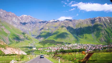 Driving-Along-Scenic-Valley-Floor-Road-In-Kazbegi-In-Georgia-With-Epic-Mountain-Views