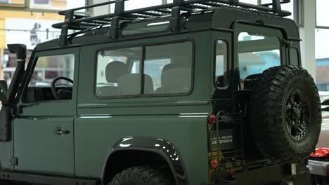 side-part-of-land-rover-defender-classic-moss-green-110,-british-vintage-safari-wagon