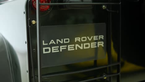 rear-logo-of-land-rover-defender-classic-moss-green-110,-british-vintage-safari-car