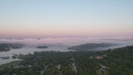 Time-lapse-drone-video-of-early-morning-fog-on-a-lake-at-sunrise
