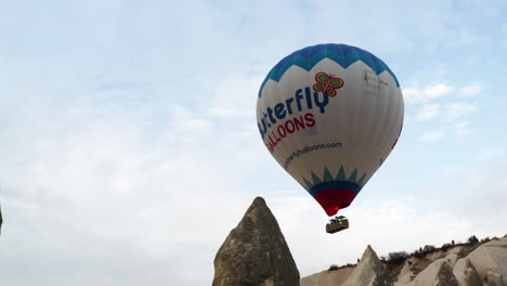 Tourists-Riding-Hot-Air-Balloon-Over-Fairy-Chimneys-At-Cappadocia-In-Turkey