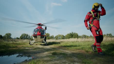 Helicopter-Rescuer-walking-from-landed-Helicopter---sunny-day-wide-shot---slowmotion