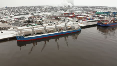 Aerial-view-of-container-ships-docked-in-the-Port-of-Saint-John,-New-Brunswick-during-winter
