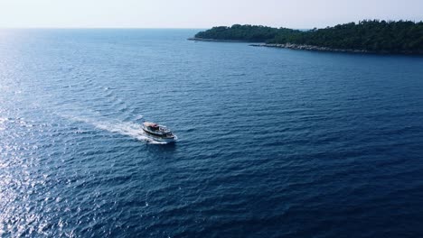 Aerial-flyover-of-a-boat-on-the-blue-waters-of-the-Adriatic-Sea,-Croatia